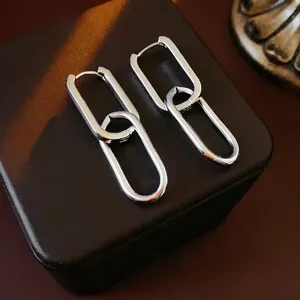 Polished silver oval chain link earrings displayed on a black leather jewelry box