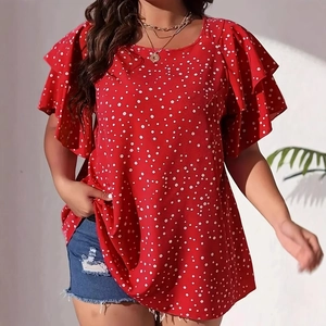 Detail of red polka dot plus size top featuring stylish ruffle sleeves and crew neck