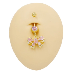 Detailed view of butterfly navel ring with pink crystals on golden stainless steel bar