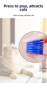 Close-up of flexible blue plastic spring cat toy showing the press-and-bounce feature