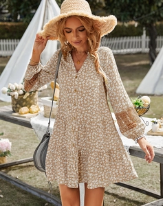 Detail of V-neck floral dress featuring intricate lace sleeves and delicate button closure