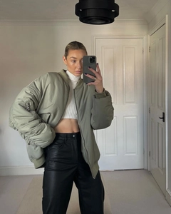 Mirror selfie showing olive green bomber jacket with gathered sleeves and black leather pants