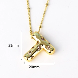 Macro view of gold letter T pendant with rhinestones showing dimensions 21mm by 20mm