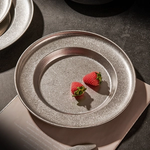Vintage stainless steel deep pasta plate with rustic hammered texture and strawberries