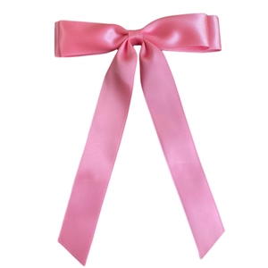 Close-up of pink satin double bow hair clip with long ribbons on white background