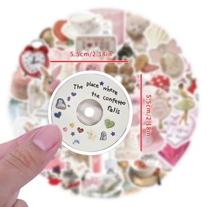 5.5cm Coquette style circular CD sticker shown in hand for luggage and laptop décor