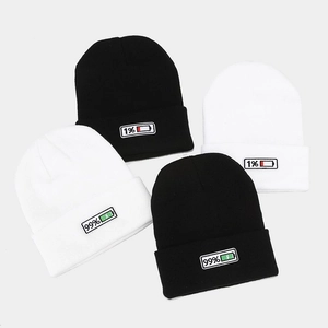 Black and white knitted beanies featuring embroidered 1% and 99% battery icons