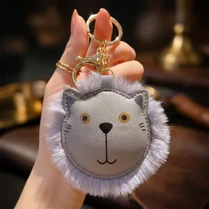 Cute grey lion plush keychain with faux leather face and golden metal carabiner clip