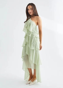 Detail view of light green halter dress with tiered ruffles and asymmetric hemline