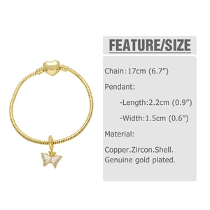 Detail of gold snake chain bracelet featuring heart clasp and zircon butterfly charm