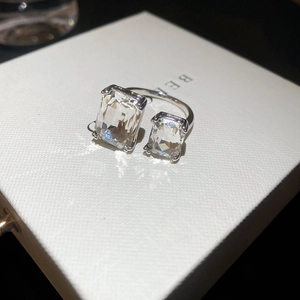 Macro detail of silver geometric open ring featuring two rectangular zircon gemstones