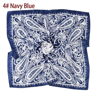 Detailed view of navy blue square silk scarf with white paisley pattern print