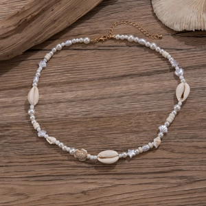 Close-up of pearl necklace with starfish and shell accents on rustic wooden texture