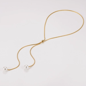Detail of adjustable gold Y-necklace with snake chain and hanging white pearls