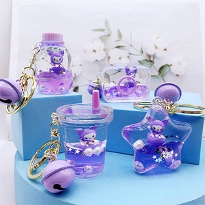 Detail of liquid quicksand keychains with purple glitter and cartoon character charms