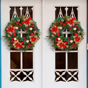 Large festive red Christmas wreath with pine needles and poinsettia flowers for door decor