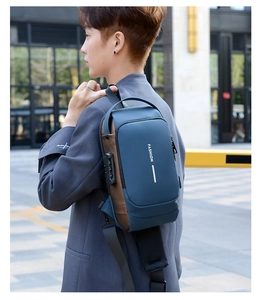 Detail view of anti-theft combination lock and USB charging port on the navy blue chest bag