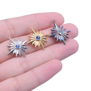 Detailed macro view of colorful star pendants with inlaid crystals on fingers