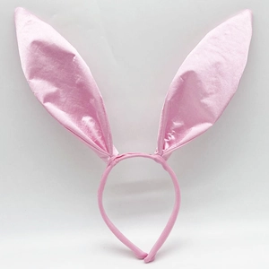 Macro view of a soft pink satin fabric wrapped bunny ear headband with silk texture detail