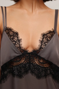 Close-up of charcoal satin camisole featuring delicate black floral lace trim details