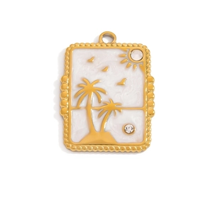 Detail of golden enamel pendant featuring palm trees and sun with sparkling rhinestones