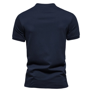 Detail of navy blue polo shirt featuring pique texture and ribbed knit cuffs for men