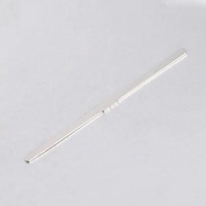 Macro shot of polished silver stainless steel blank bar with central wave detail