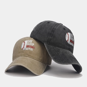 Detail of embroidered Eat Sleep Baseball Repeat slogan on washed cotton caps