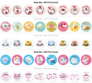 Macro detail of various 2.5cm round Happy Birthday and Women's Day decorative seal stickers