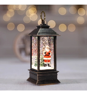 Macro view of a bronze Christmas snow globe lantern with Santa Claus and warm bokeh