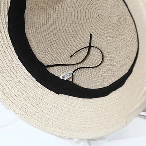 Detail view of straw hat interior with adjustable strap and sweatband texture