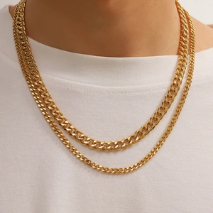 Close-up of double-layer gold twist cuban chain necklace worn on male model neck