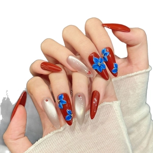 Handmade almond press-on nails featuring 3D blue flowers and red cat-eye finish