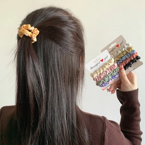 Set of pastel polka dot scrunchies in minimalist Korean style worn on ponytail hair