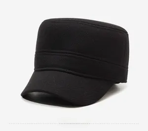Close-up of black wool fabric texture and metal logo detail on the warm cadet cap