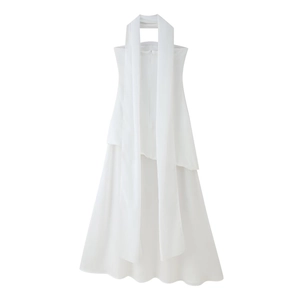 Detail of white halter neck dress featuring long decorative ribbons and A-line cut