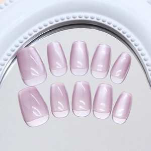 Elegant mauve cat-eye press-on nails with shimmering wide-band light effect on a mirror
