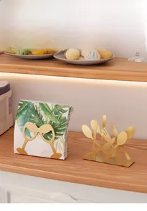 Detail of artistic gold metal napkin holders in wine glass and cutlery shapes