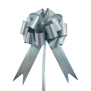 Detail of a silver-grey metallic gift bow with layered loops and elegant ribbon tails