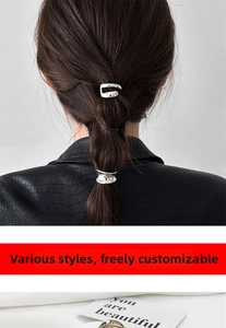 Close-up of minimalist silver irregular textured metal hair clips on a ponytail