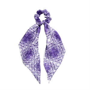 Satin scarf scrunchie with periwinkle paisley print and long ribbons on white background