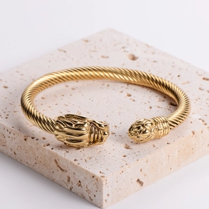18k gold plated stainless steel twisted wire cuff bracelet featuring ornate dragon head ends