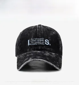 Close-up of distressed baseball cap with embroidery and vintage washed texture