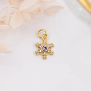 Detailed view of 18k gold plated snowflake pendant with purple zircon and tiny diamonds