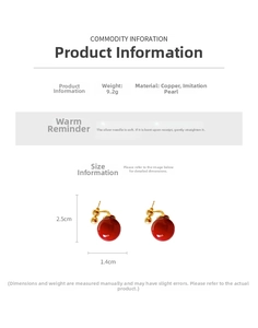 Detailed view of red drop pearl earrings with gold brackets and silver needle posts