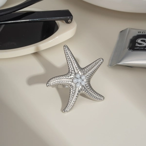 Exaggerated starfish pearl ring in stainless steel with elegant summer seaside aesthetic