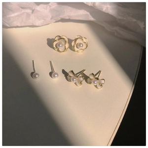 Detailed set of camellia flower, pearl, and bow earrings with gold-plated finish