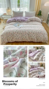 Detail of floral embroidery on soft purple washed cotton bedding with smooth texture