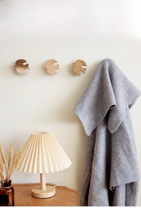 Detail of bird-shaped wooden wall hooks showing thick solid wood and smooth grain texture