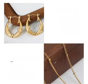 Detail of 18k gold plated titanium steel koi fish jewelry set with intricate textures